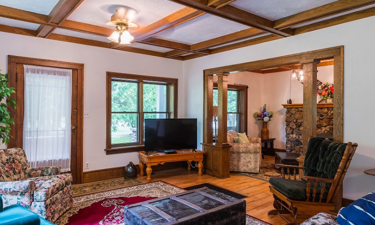 A living room with wooden floors and white walls.