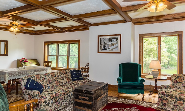 A living room with a couch, chair and table.