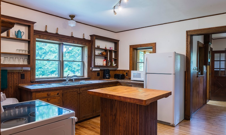 A kitchen with wooden cabinets and white appliances.