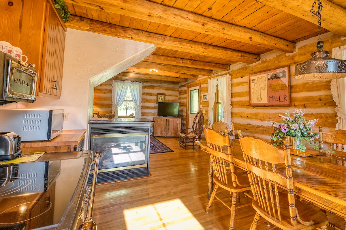 A living room with wood floors and wooden furniture.