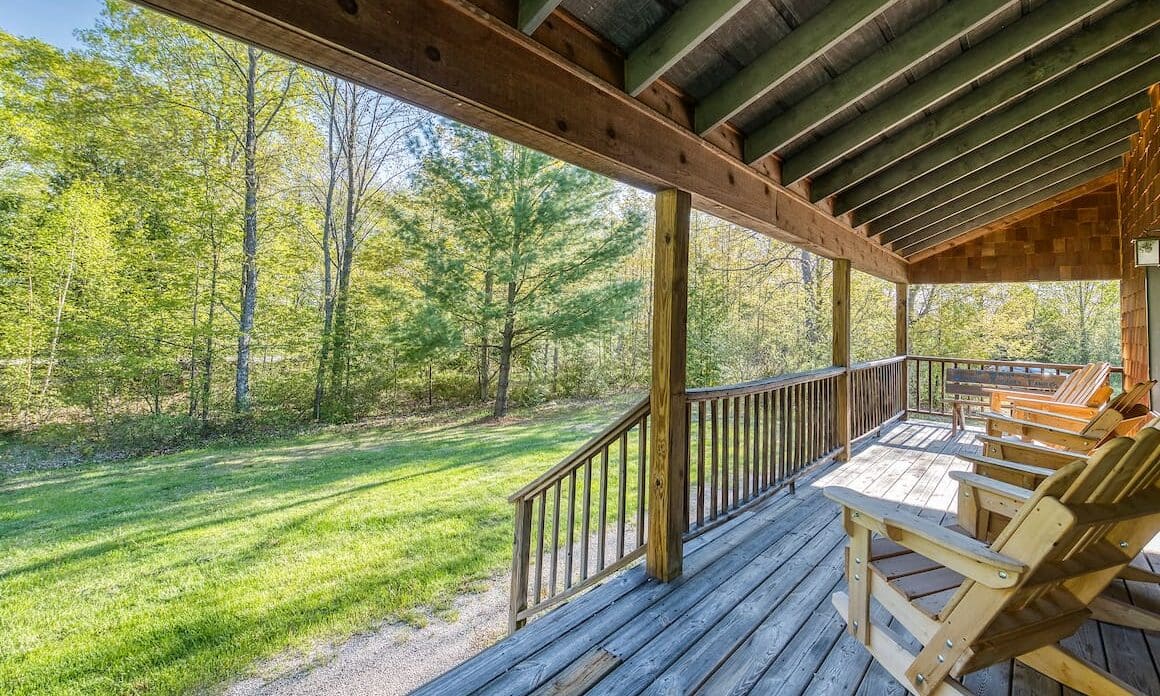 A porch with wooden steps and a bench.