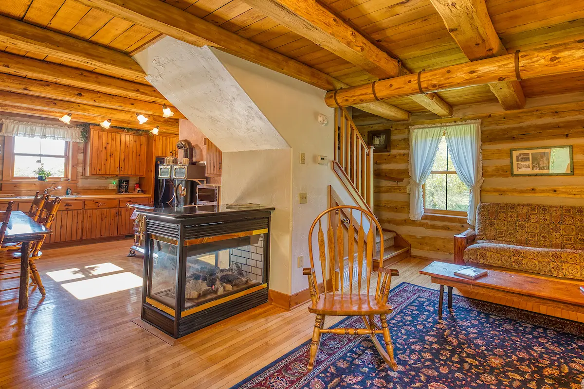 A living room with wood floors and wooden furniture.