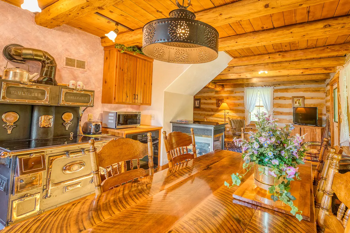 A kitchen with wooden floors and walls.